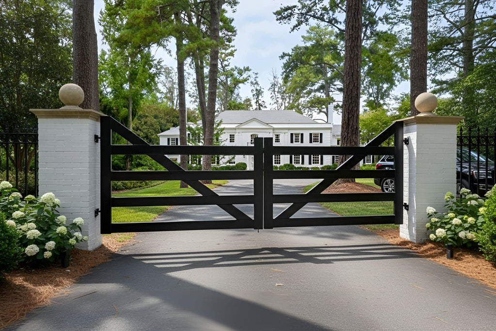 Wooden gate at the entrance of a driveway with a white house in the background