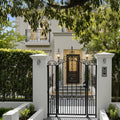 Elegant house with a black wrought iron gate and white columns