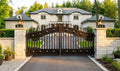 Luxurious mansion with a large ornate gate in a well-maintained garden.