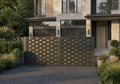 Modern house with a decorative metal gate and well-maintained garden.